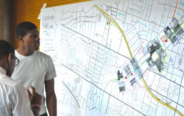 Students look at Dr. Yanni Loukissas’s LMC 2400 class project, which shows various aspects of the Westside Beltline Trail, created in the “Atlanta Map Room” 