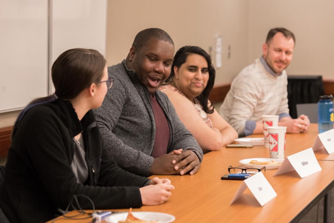 students and faculty at a table session